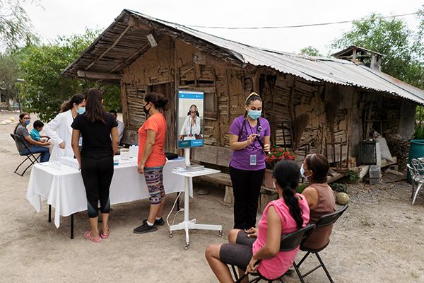  healthcare providers talk to people in a rural area