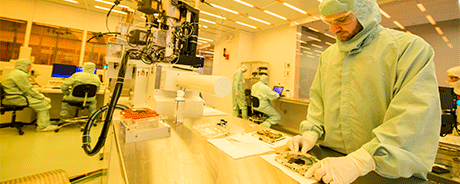 Two people in PPE, in a lab setting