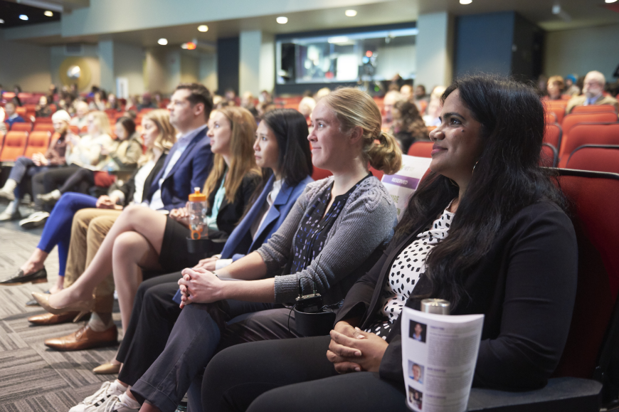 Participants of the 3MT competition sit in a row