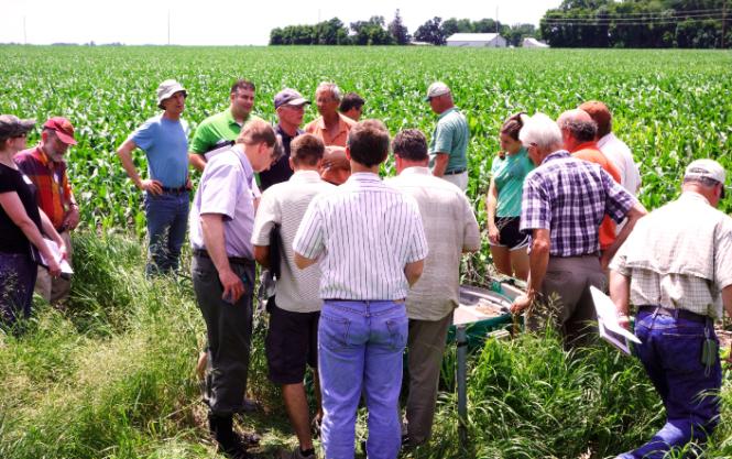 A group of people on a farm having a discussion
