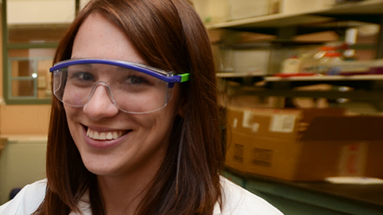 picture of Bridget Ulrich wearing lab safety goggles, in a laboratory workspace