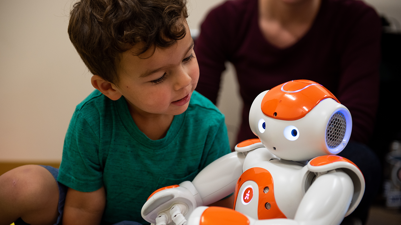 Child interacting with robot