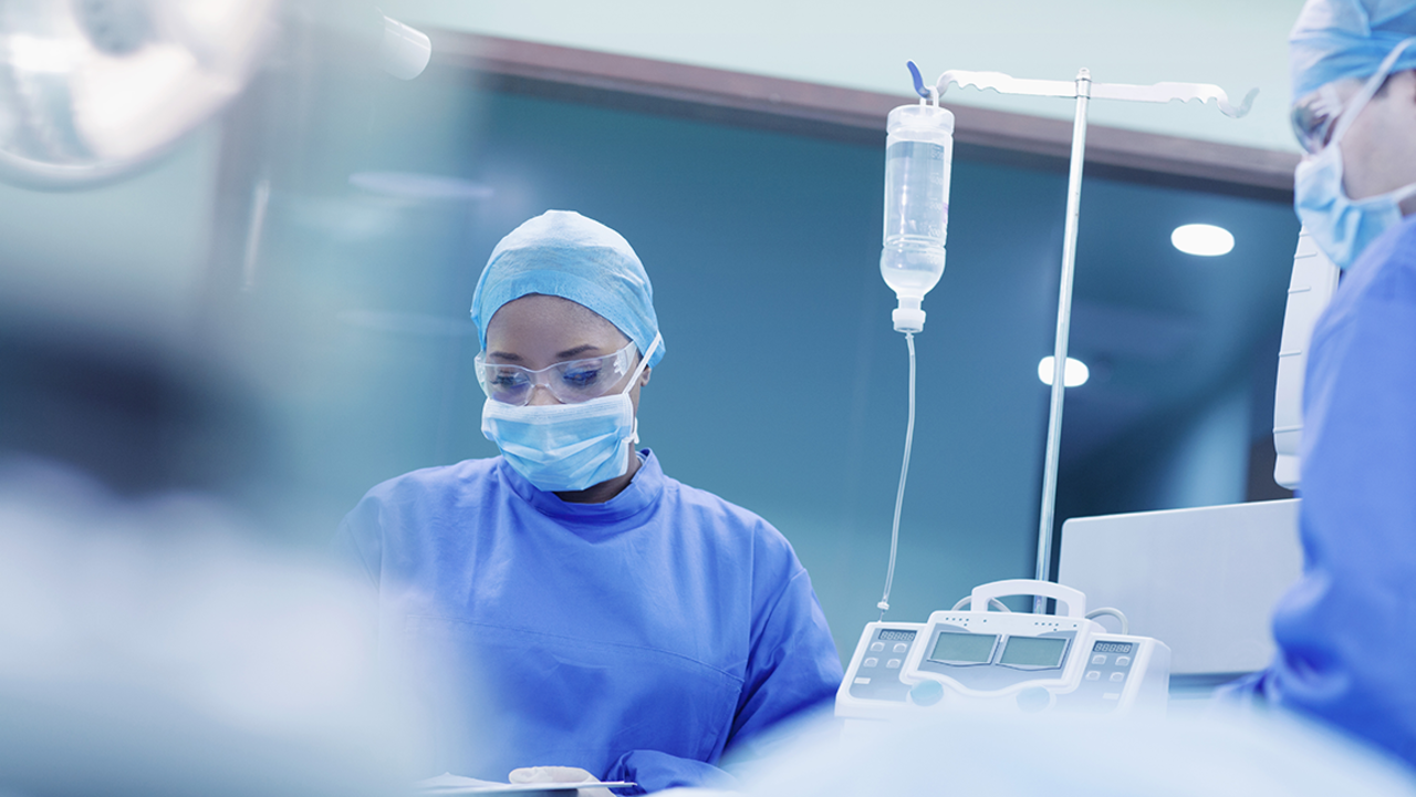 medical professionals in surgery mask and robes, in surgery setting