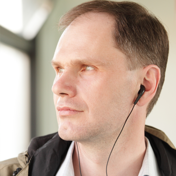 Man listening to a podcast through earphones