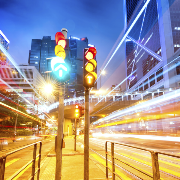 Long exposure photo of traffic lights amid busy city traffic