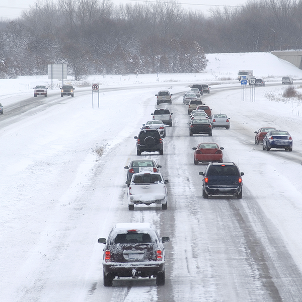 Cars and trucks driving on a divided Minnesota highway in snow