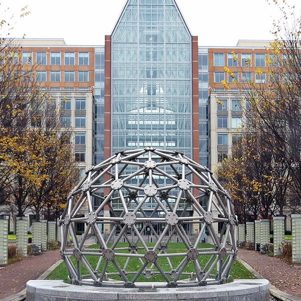 Picture of a building with plaza and sculpture out front